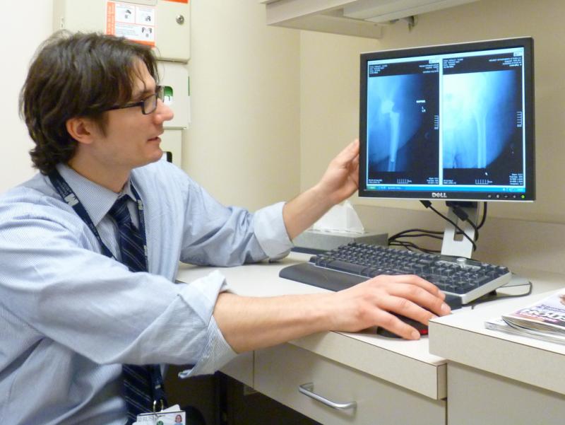Physician looking at X-ray images