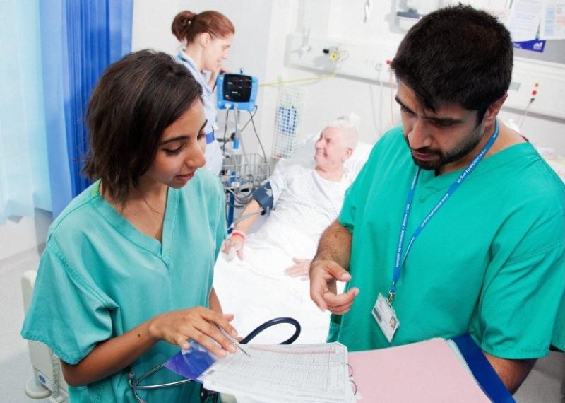 Two nurses looking at a chart Nurses viewing patient information