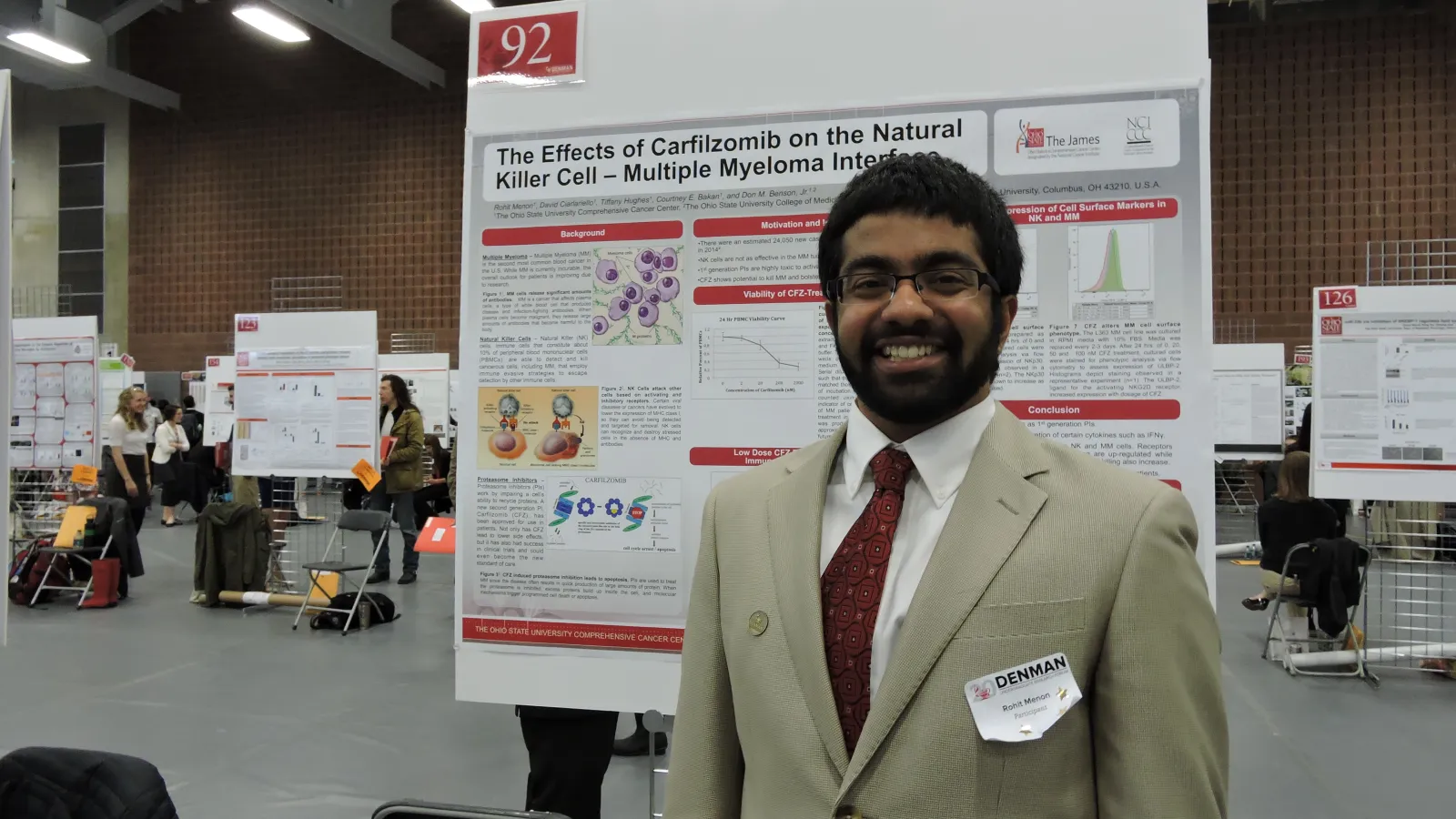 Student with poster at the denman
