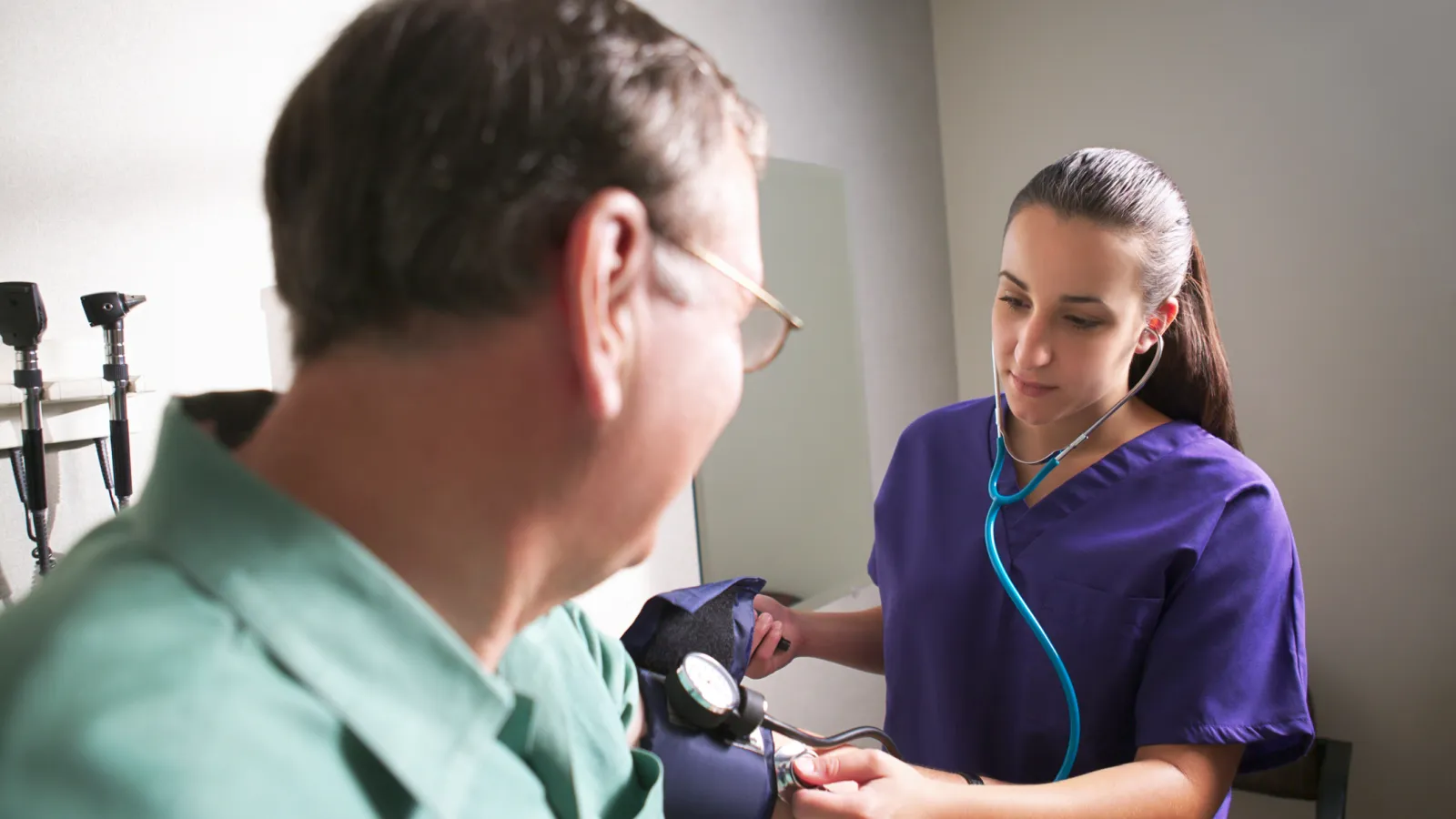 A Physician's Assistant caring for a patient.