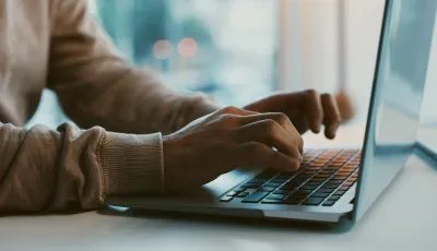 A person typing on a computer