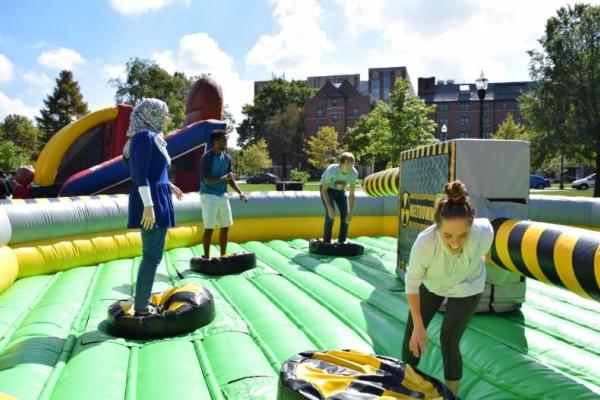 Students playing a game on the inflatable at field day