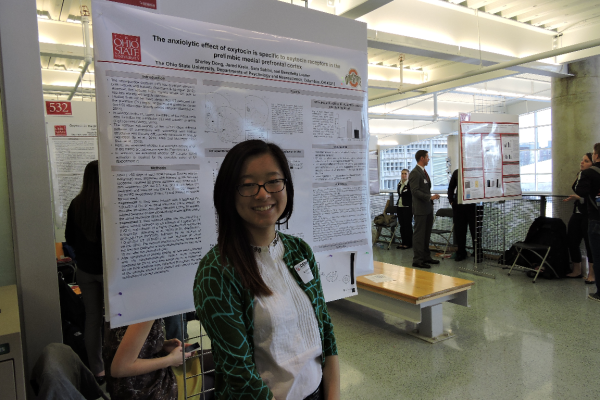 Student with research poster at the denman 