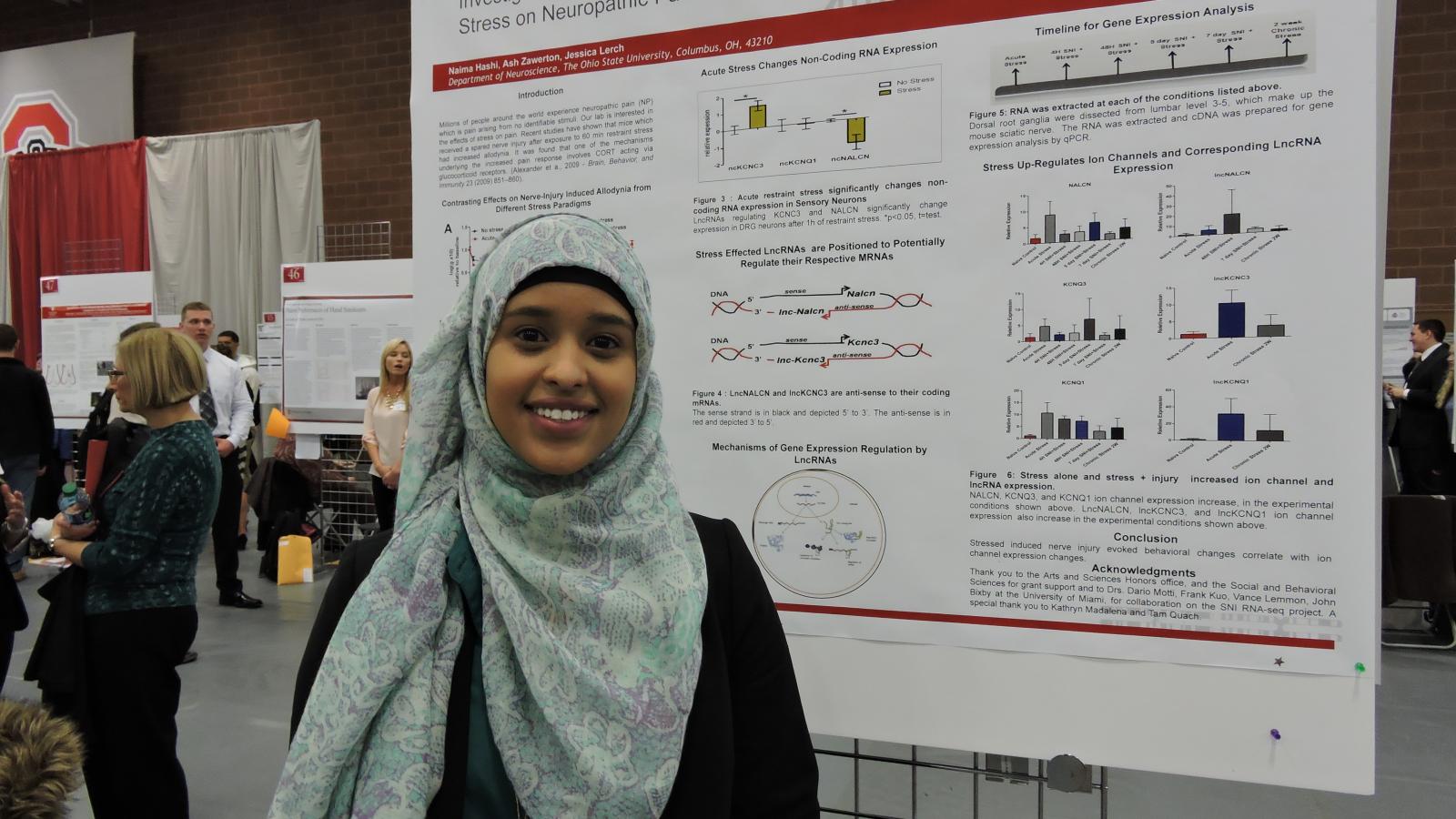Student with research poster at the denman 