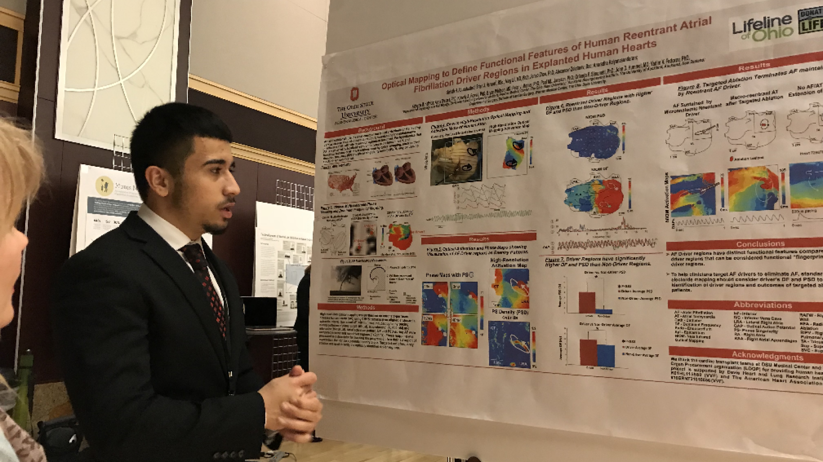 Student at the Denman with research poster