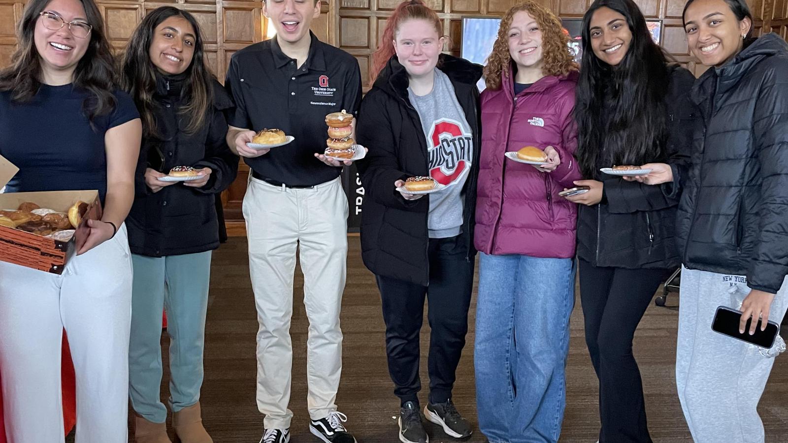 People standing with donuts