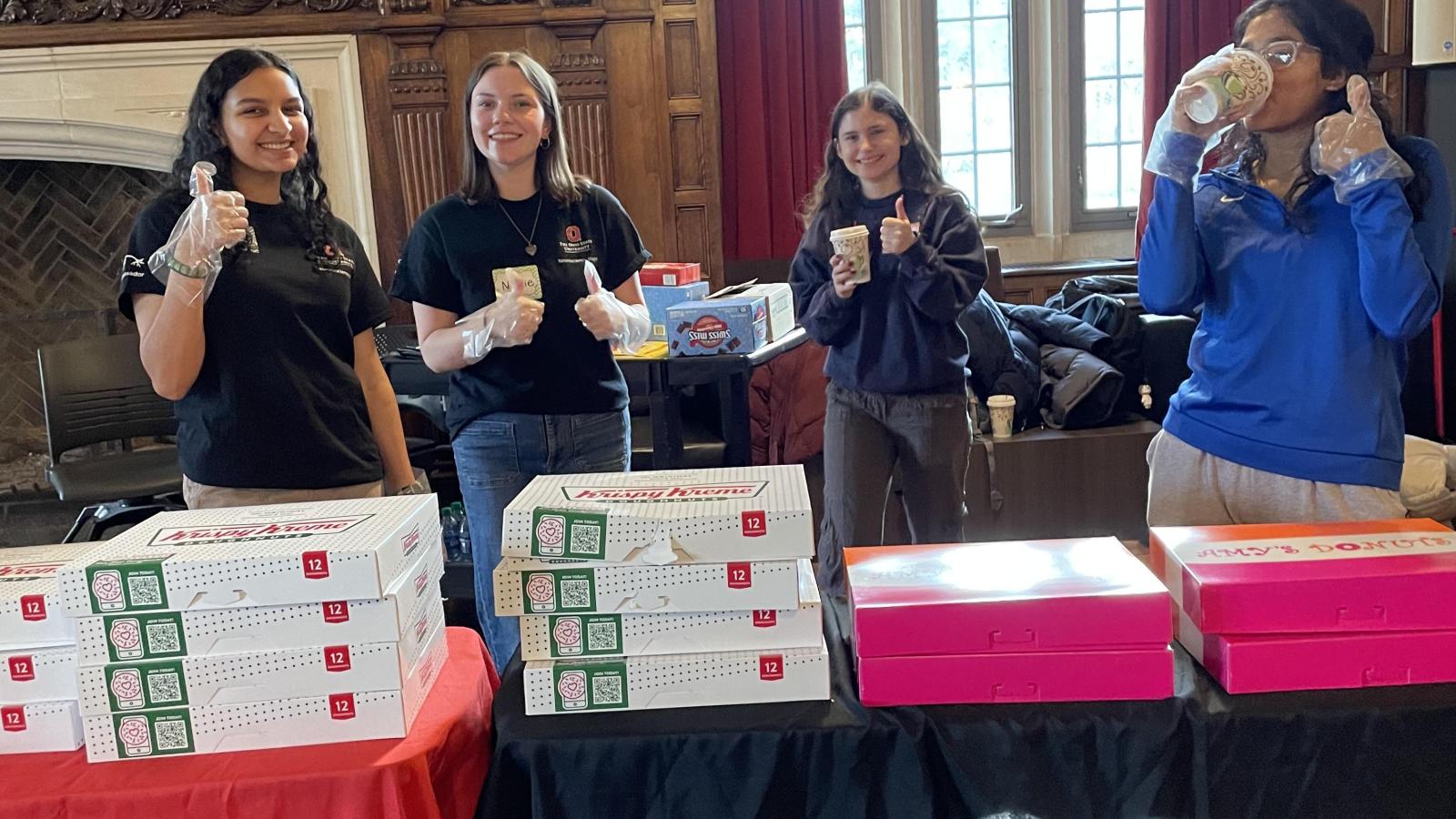 People passing out donuts